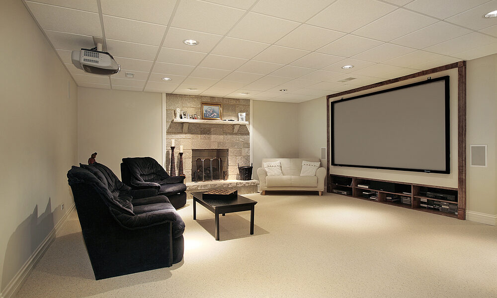 Basement with stone fireplace and large screen TV